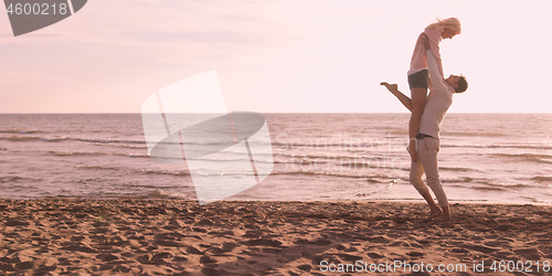 Image of Loving young couple on a beach at autumn on sunny day