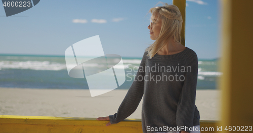 Image of Young woman enjoying the warm autumn day