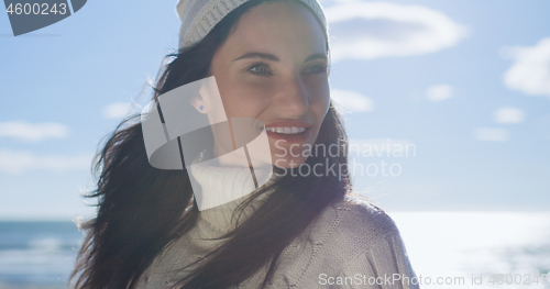 Image of Girl In Autumn Clothes Smiling on beach