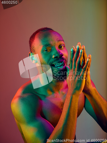 Image of Close up portrait of a young naked african man looking at camera indoors