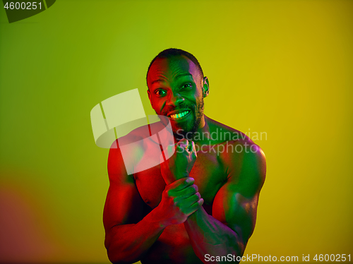 Image of Close up portrait of a young naked african man looking at camera indoors