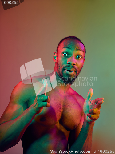 Image of Close up portrait of a young naked african man looking at camera indoors