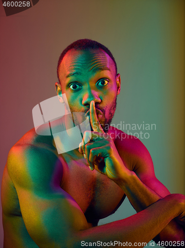 Image of Close up portrait of a young naked african man looking at camera indoors