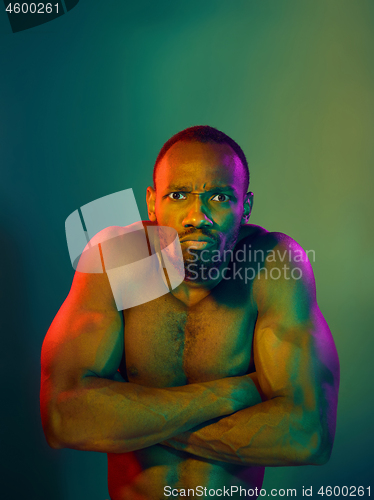 Image of Close up portrait of a young naked african man looking at camera indoors