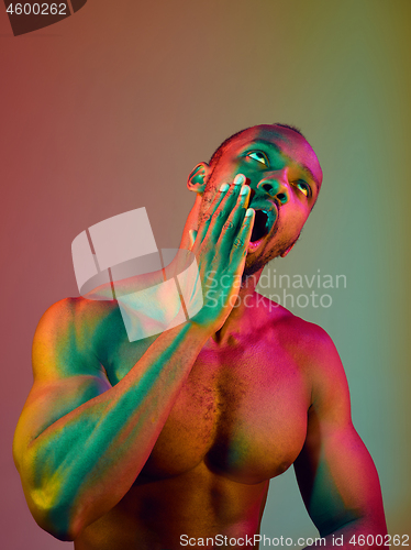 Image of Close up portrait of a young naked african man looking at camera indoors