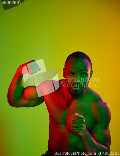 Image of Close up portrait of a young naked african man looking at camera indoors