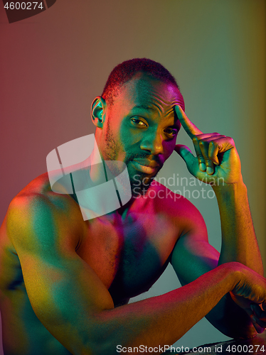 Image of Close up portrait of a young naked african man looking at camera indoors