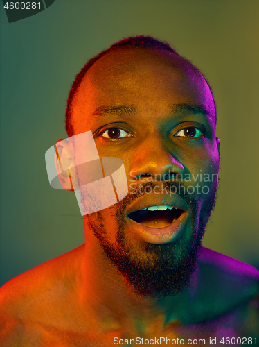 Image of Close up portrait of a young naked african man looking at camera indoors