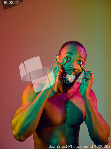 Image of Close up portrait of a young naked african man looking at camera indoors