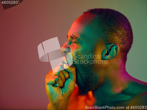 Image of Close up portrait of a young naked african man looking at camera indoors
