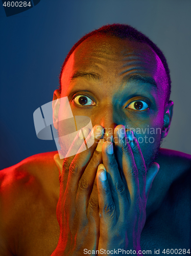 Image of Close up portrait of a young naked african man looking at camera indoors