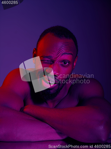 Image of Close up portrait of a young naked african man looking at camera indoors