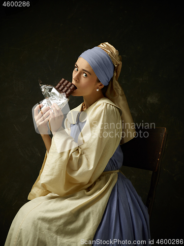 Image of Medieval Woman in Historical Costume Wearing Corset Dress and Bonnet.