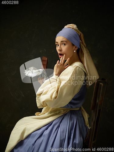 Image of Medieval Woman in Historical Costume Wearing Corset Dress and Bonnet.