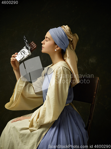 Image of Medieval Woman in Historical Costume Wearing Corset Dress and Bonnet.