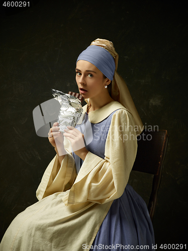 Image of Medieval Woman in Historical Costume Wearing Corset Dress and Bonnet.