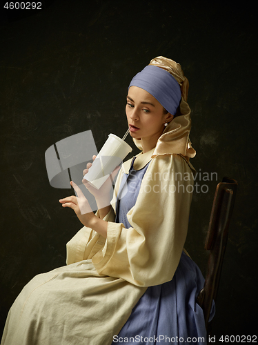 Image of Medieval Woman in Historical Costume Wearing Corset Dress and Bonnet.