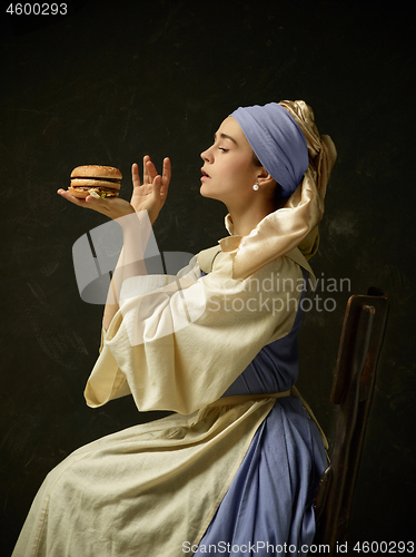 Image of Medieval Woman in Historical Costume Wearing Corset Dress and Bonnet.