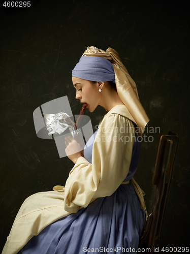 Image of Medieval Woman in Historical Costume Wearing Corset Dress and Bonnet.