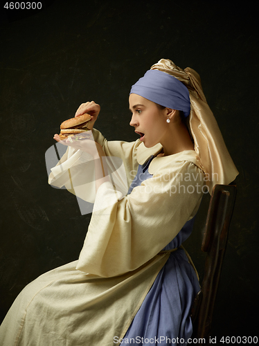 Image of Medieval Woman in Historical Costume Wearing Corset Dress and Bonnet.