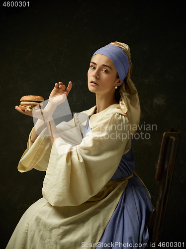 Image of Medieval Woman in Historical Costume Wearing Corset Dress and Bonnet.