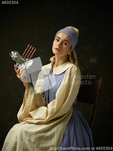 Image of Medieval Woman in Historical Costume Wearing Corset Dress and Bonnet.