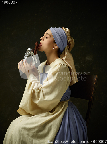 Image of Medieval Woman in Historical Costume Wearing Corset Dress and Bonnet.