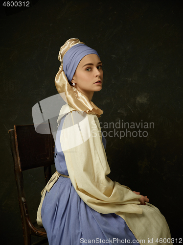 Image of Medieval Woman in Historical Costume Wearing Corset Dress and Bonnet.