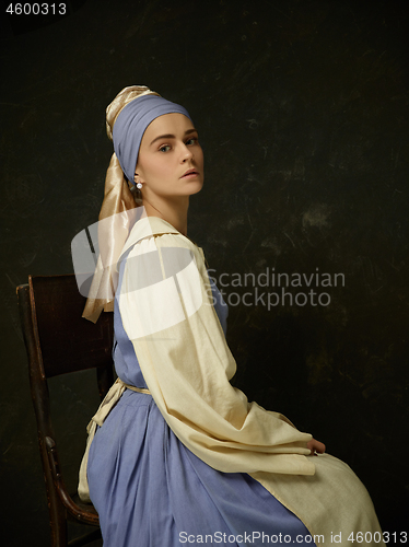 Image of Medieval Woman in Historical Costume Wearing Corset Dress and Bonnet.