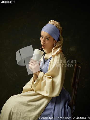 Image of Medieval Woman in Historical Costume Wearing Corset Dress and Bonnet.