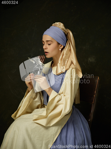 Image of Medieval Woman in Historical Costume Wearing Corset Dress and Bonnet.