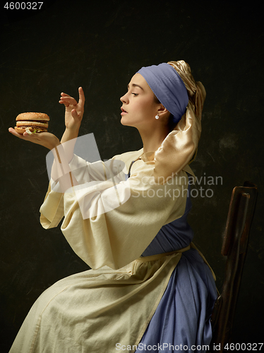 Image of Medieval Woman in Historical Costume Wearing Corset Dress and Bonnet.