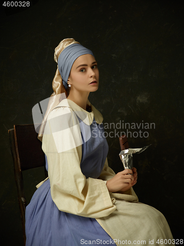 Image of Medieval Woman in Historical Costume Wearing Corset Dress and Bonnet.