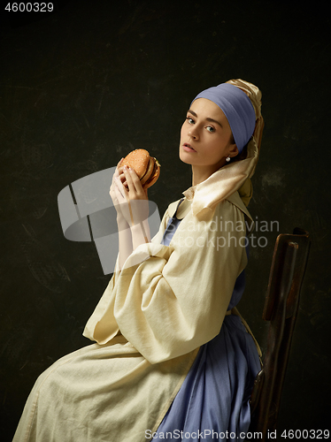 Image of Medieval Woman in Historical Costume Wearing Corset Dress and Bonnet.