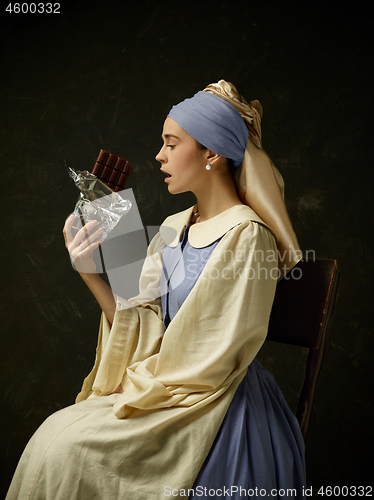 Image of Medieval Woman in Historical Costume Wearing Corset Dress and Bonnet.