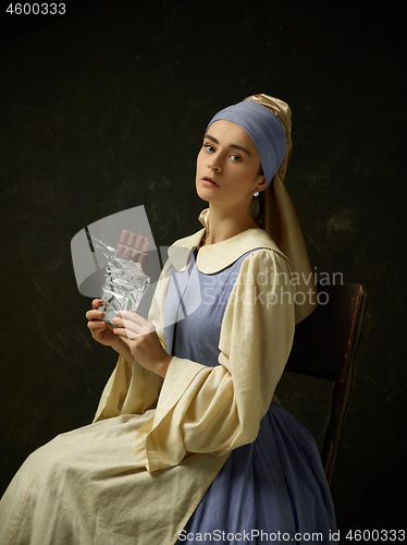 Image of Medieval Woman in Historical Costume Wearing Corset Dress and Bonnet.