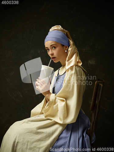 Image of Medieval Woman in Historical Costume Wearing Corset Dress and Bonnet.