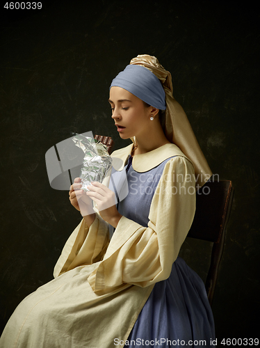 Image of Medieval Woman in Historical Costume Wearing Corset Dress and Bonnet.