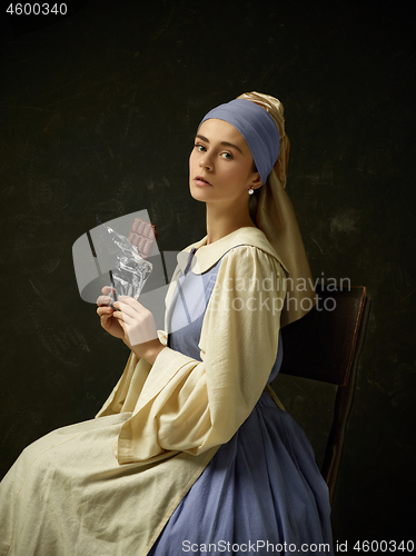 Image of Medieval Woman in Historical Costume Wearing Corset Dress and Bonnet.