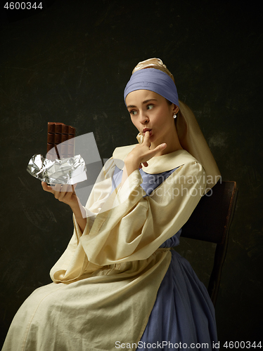 Image of Medieval Woman in Historical Costume Wearing Corset Dress and Bonnet.