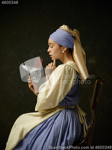 Image of Medieval Woman in Historical Costume Wearing Corset Dress and Bonnet.