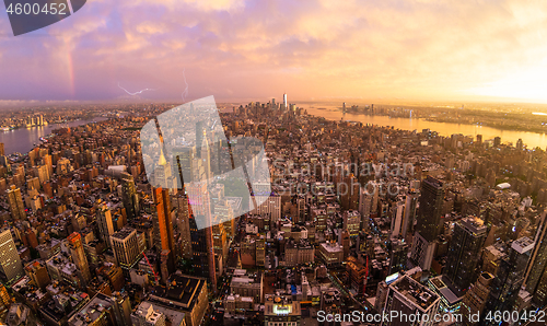 Image of New York City skyline with Manhattan skyscrapers at dramatic stormy sunset, USA.