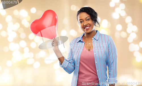 Image of african american woman with heart-shaped balloon