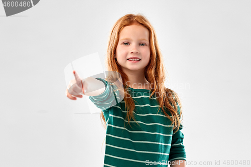 Image of smiling red haired girl pointing to you