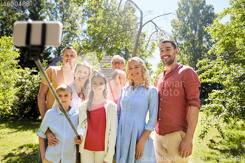 Image of happy family taking selfie in summer garden