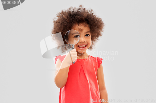 Image of african girl looking through magnifying glass