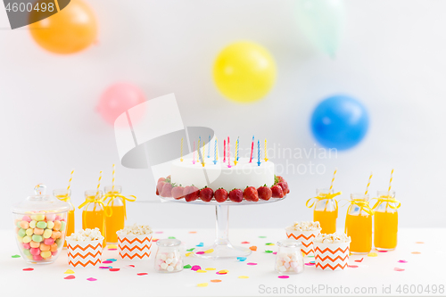 Image of birthday cake, juice, popcorn and marshmallow