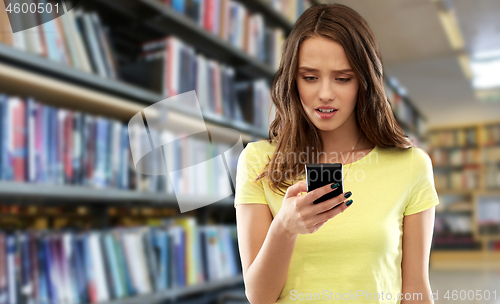 Image of young woman or teenage girl using smartphone