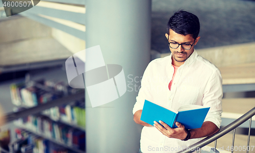 Image of hindu student boy or man reading book at library