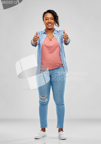 Image of happy african american woman showing thumbs up